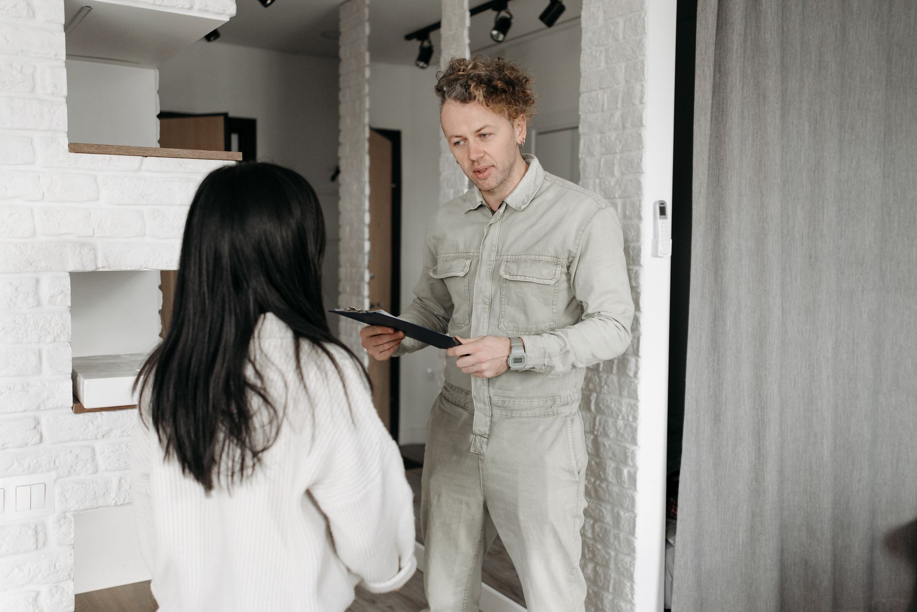 Courier hands over a package to a customer in a modern indoor setting, promoting online shopping services.